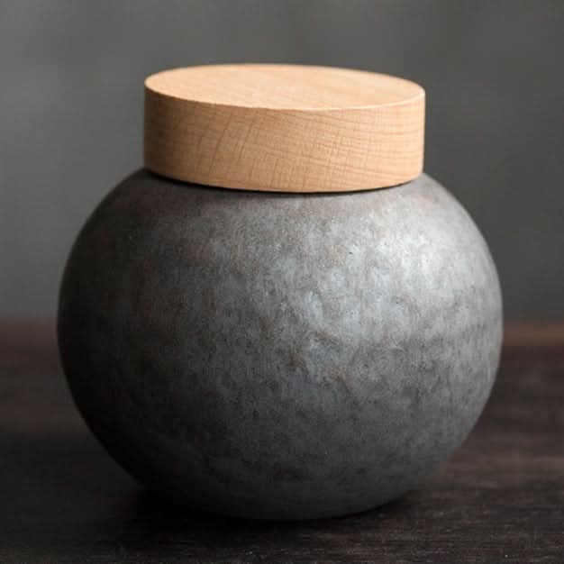 Gray ceramic tea jars with wooden lid, modern home decor accent.